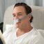 Man wearing ResMed AirFit P10 and reading | Intus Heathcare