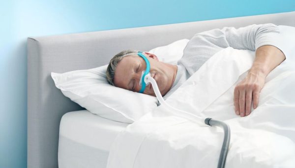 Man wearing Evora Full Face CPAP Mask in bed | Intus Healthcare