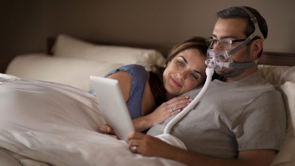 CPAP Therapy user in bed | Intus Healthcare